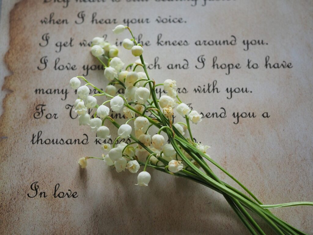 A vintage letter with white flowers resting on it