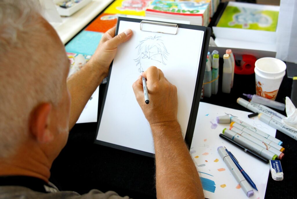 A man drawing a cartoon character  