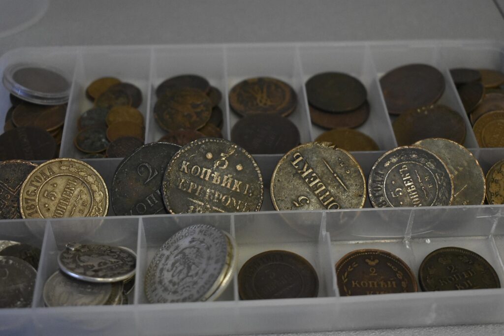 A sectioned box with vintage coins inside
