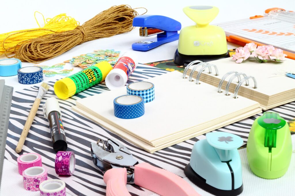 Scrapbooking supplies laid out on a white surface 